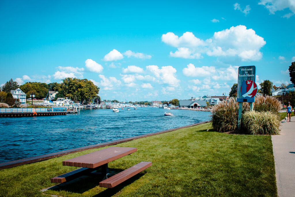 Welcome to South Haven sign by the water with pinic table