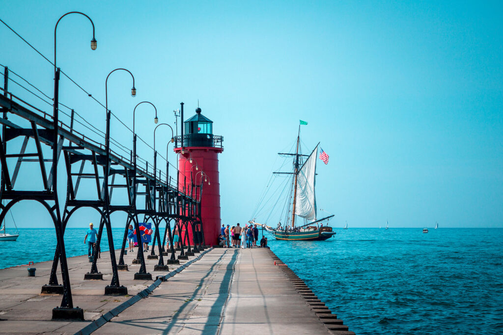 Dock with light house and ship in the water