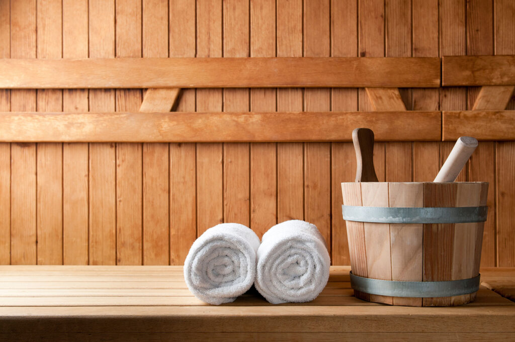 Sauna two towels and bucket with supplies