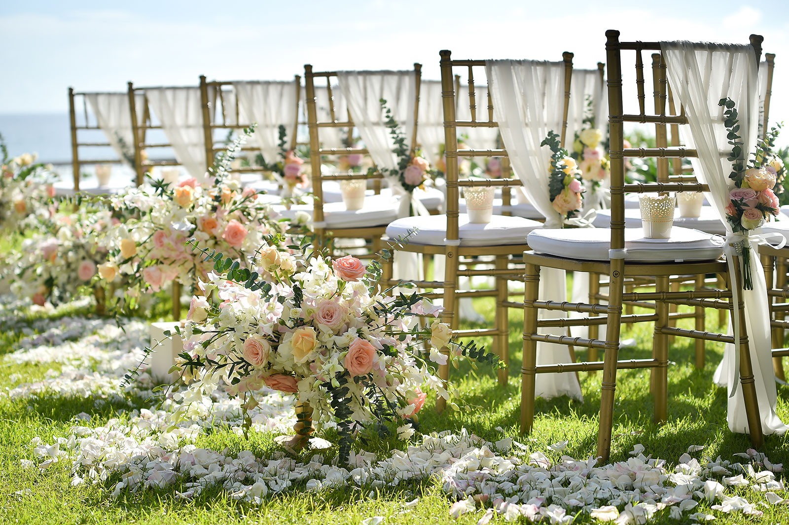Wedding set up with chairs decorated with flowers and petals