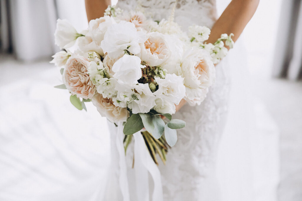 Wedding, woman holding her bouquet in her wedding dress