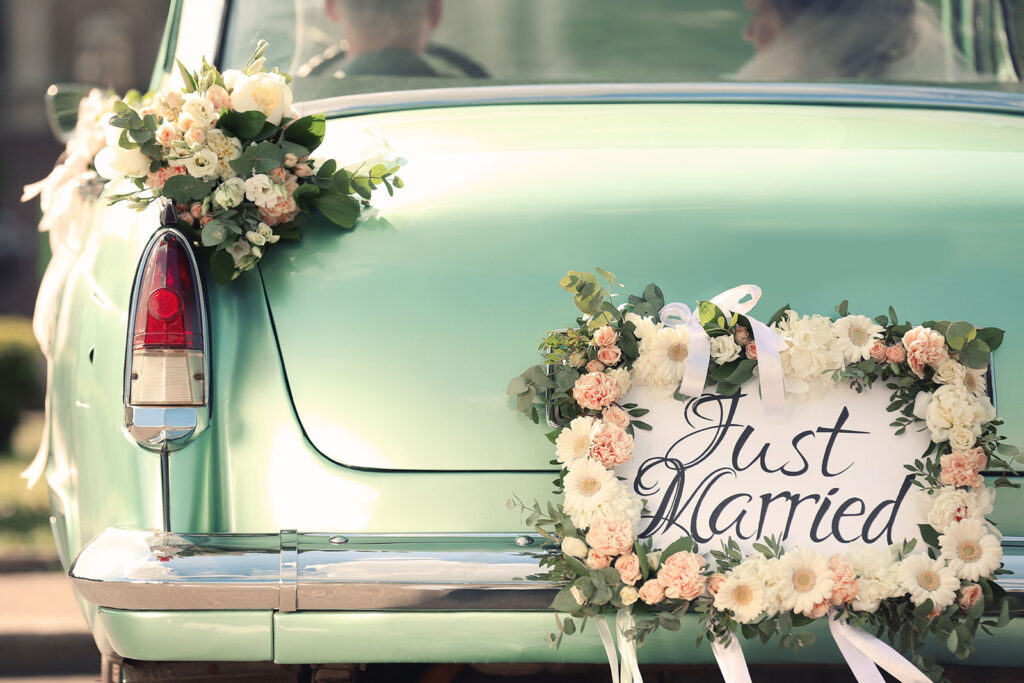 Lake Bluff Inn and Suites weddings bumper view of car with just married sign and flowers